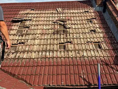 Painted, cracked and missing roof tiles on a house in Bromley